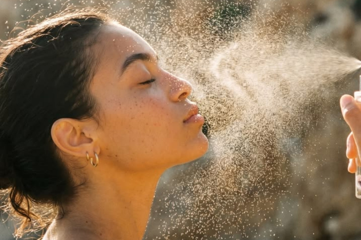 Woman spraying a skincare mist onto her skin