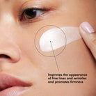 Woman with A.G.E Interrupter Advanced cream on her cheek